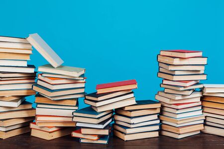 many of educational books for learning preparation for college exams on a blue backgroundの写真素材