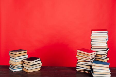 many of educational books for learning the preparation for exams on a red backgroundの写真素材
