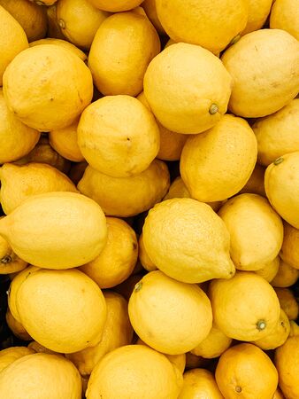 lots of ripe delicious lemons for eating like a backgroundの写真素材