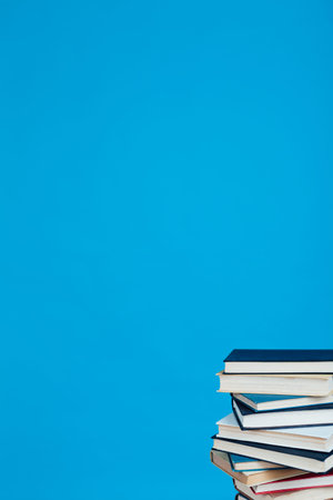 many of educational books for learning preparation for college exams on a blue background