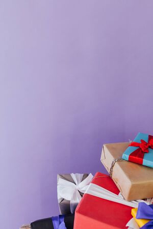 lots of colorful Christmas birthday gifts new year purple backgroundの写真素材