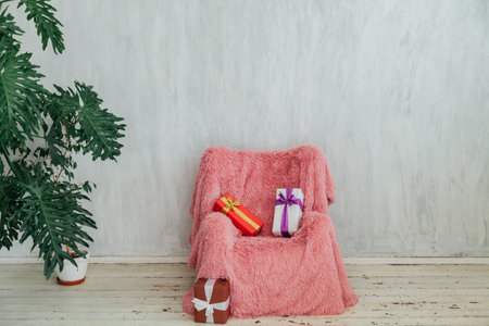 pink chair with home plant in the interior of the gray room
