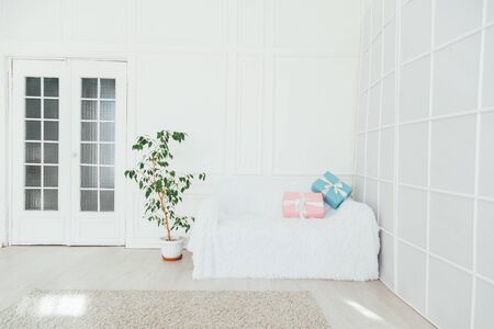 white sofa with gifts in the interior of the roomの写真素材