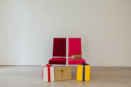 two chairs with birthday gifts at the white wallの写真素材