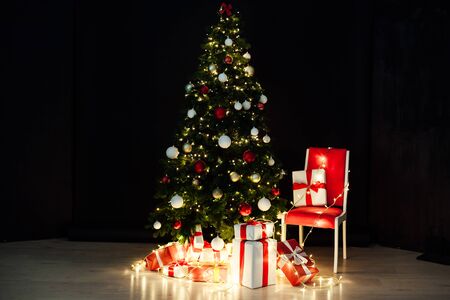 Christmas tree with garlands and New Year's giftsの写真素材