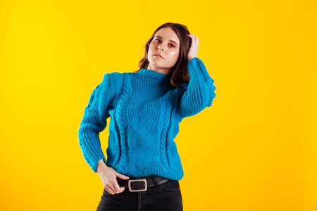 Beautiful fashionable brunette woman in blue sweaterの写真素材
