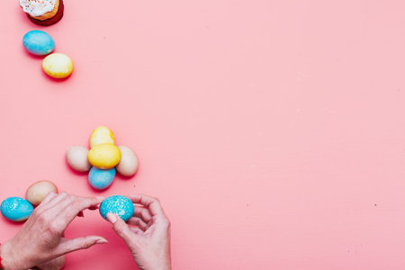 multi-colored eggs for the Easter holiday on a pink background
