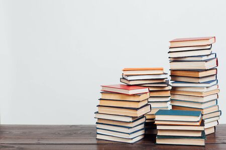 a lot of stacks of educational books for college exams in the library on a white backgroundの写真素材