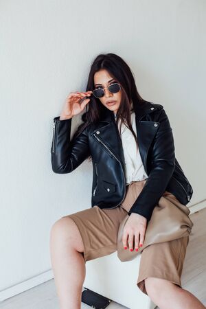 Portrait of a beautiful fashionable oriental brunette woman in black sunglassesの写真素材
