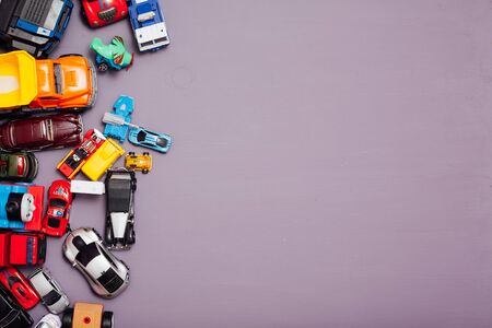 Lots of childrens car toys for child development games on a backgroundの写真素材