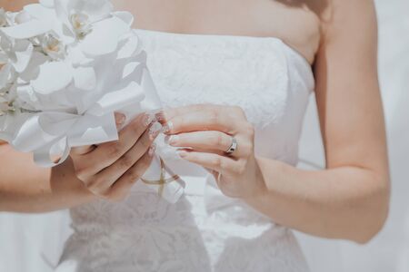 bride holding bouquet in hands beautiful whiteの写真素材