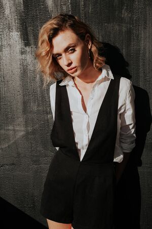 Beautiful fashionable blonde woman in white shirt and shortsの写真素材