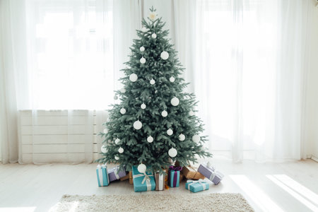 The interior of the white room with a blue Christmas tree with gifts for the new year decor winter...