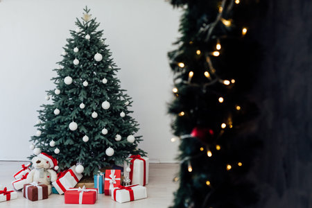 The interior of the white room with a blue Christmas tree with gifts for the new year decor winter postcardの写真素材