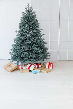 Christmas tree blue pine with gifts interior decor room New year winter holidaysの写真素材