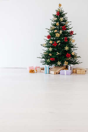 Garland Christmas tree pine with gifts for the new year decor interior red whiteの写真素材