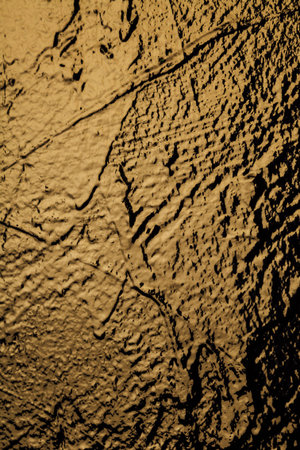 Bronze wall illuminated by light texture structure background