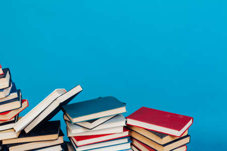 stacks of books for reading and education on a blue background in the university libraryの写真素材