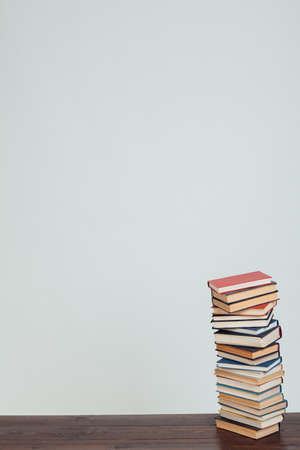 many stacks of educational books to study in the university library as a backgroundの写真素材