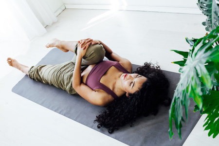 Beautiful woman on the floor of yoga gymnastics flexible stretching asana fitnessの写真素材