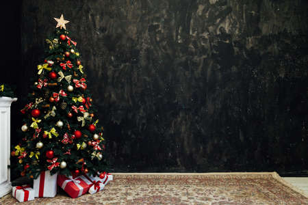 Christmas tree with red decor and gifts in the interior of the new yearの写真素材