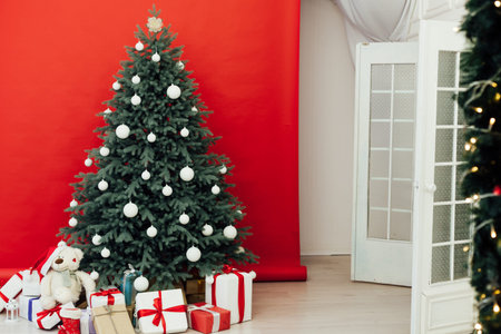 Blue Christmas tree decor pine on new year red background postcard interiorの写真素材