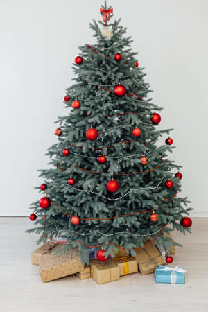 Christmas tree with gift decor pine on new year interior background postcard holiday winterの写真素材