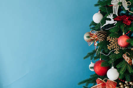 Christmas tree pine decorated with toys with gifts in the interior of the room blue background New Yearの写真素材