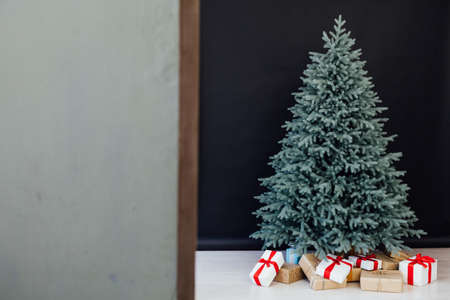 Christmas tree blue pine with gifts interior decor room New year winter holidaysの写真素材