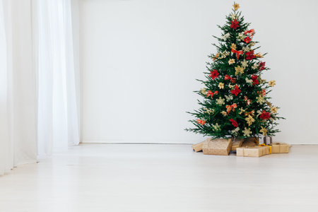 Christmas tree pine with gifts decor interior of the house new yearの写真素材