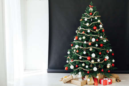 Christmas tree pine black interior room new year decor garland gifts postcardの写真素材