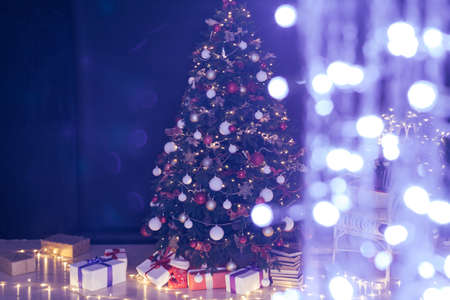 Christmas tree with gift lights garland decor new yearの写真素材