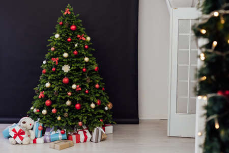 Christmas tree pine with gifts for the new year black decor winterの写真素材