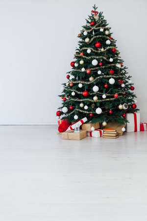 Christmas interior of the Christmas tree pine new year presents a postcardの写真素材