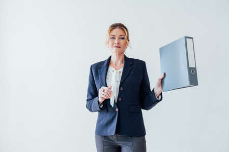Beautiful business woman with paper folders in the business officeの写真素材