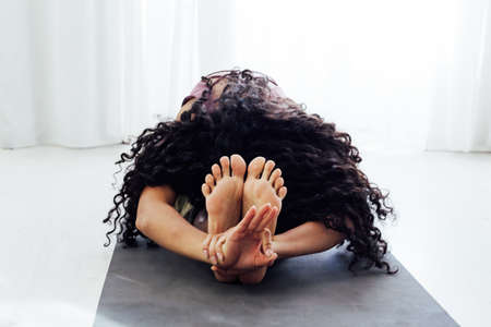 Female brunette engaged in yoga fitness asana body flexibilityの写真素材