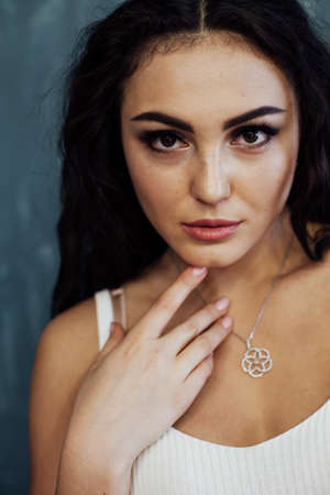 Portrait of a beautiful fashionable brunette woman in stylish clothesの写真素材