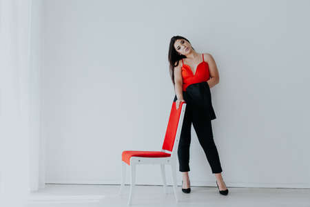 Beautiful oriental fashionable brunette woman in red black dressの写真素材