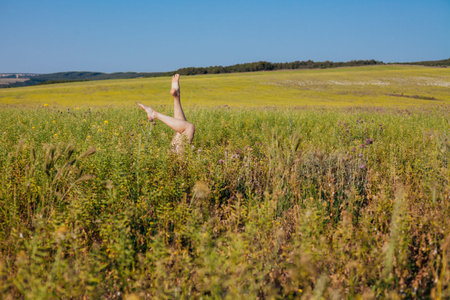 beautiful womans feet in a field of tall grass