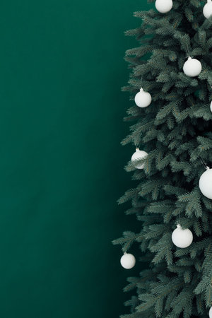 Christmas tree with presents underneath in living room. White room.