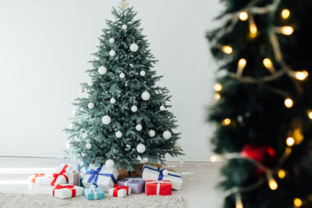 New Years decoration Christmas tree with gifts and garlands interior