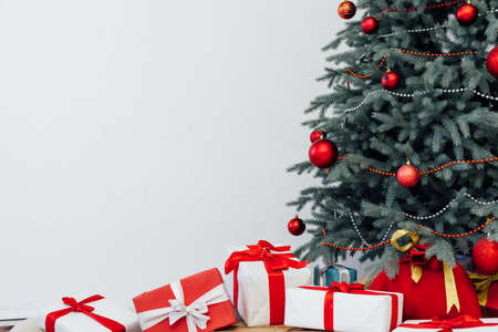 Beautiful holdiay decorated room with Christmas tree with presents under itの写真素材