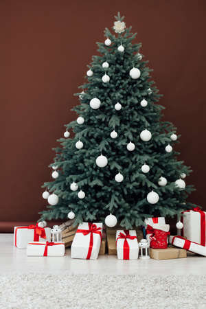 Christmas tree pine with gifts new year interior decor backgroundの写真素材