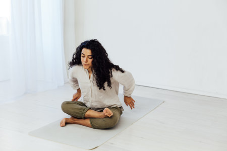 Female brunette engaged in yoga asana gymnastics sport