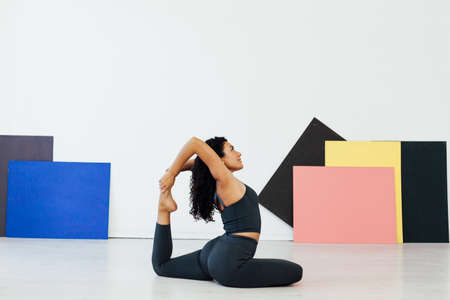 Beautiful brunette woman engaged in yoga asana gymnastics fitness flexibility bodyの写真素材