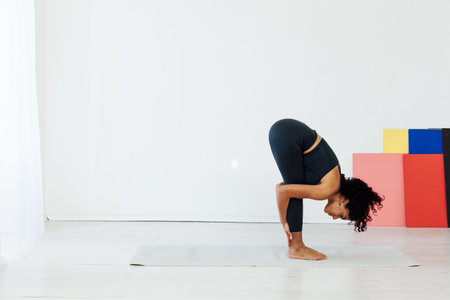 Beautiful brunette woman engaged in yoga asana gymnastics fitness flexibility body