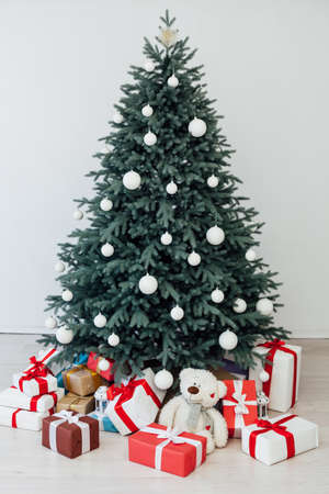 Christmas tree with gift decoration decor balls garlands new year interiorの写真素材