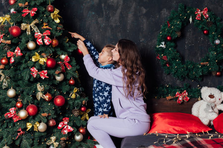 Mom and boy decorates Christmas tree Christmas New Yearの写真素材