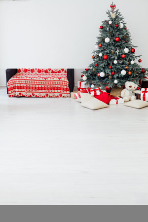 The interior of the white room Christmas tree New Year holiday gifts decorの写真素材