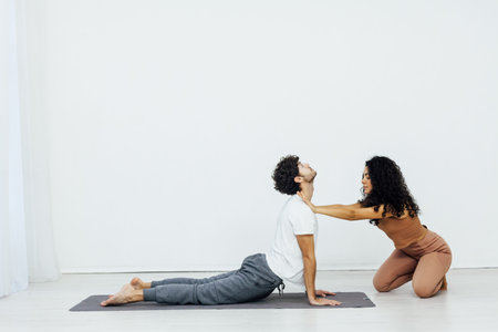 Man engaged in yoga with asana gymnastics fitness instructor